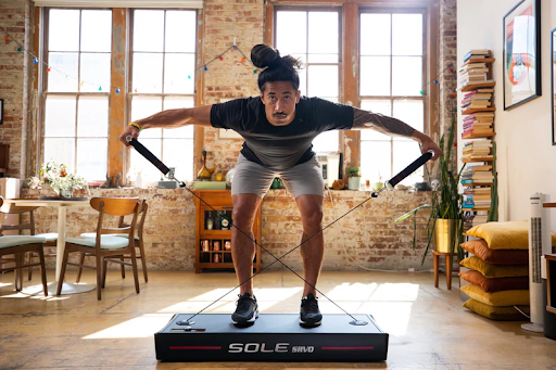 Man using the SOLE SRVO All-in-One Trainer.