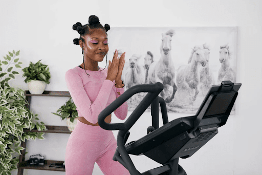 Woman using the SOLE E98 Elliptical.