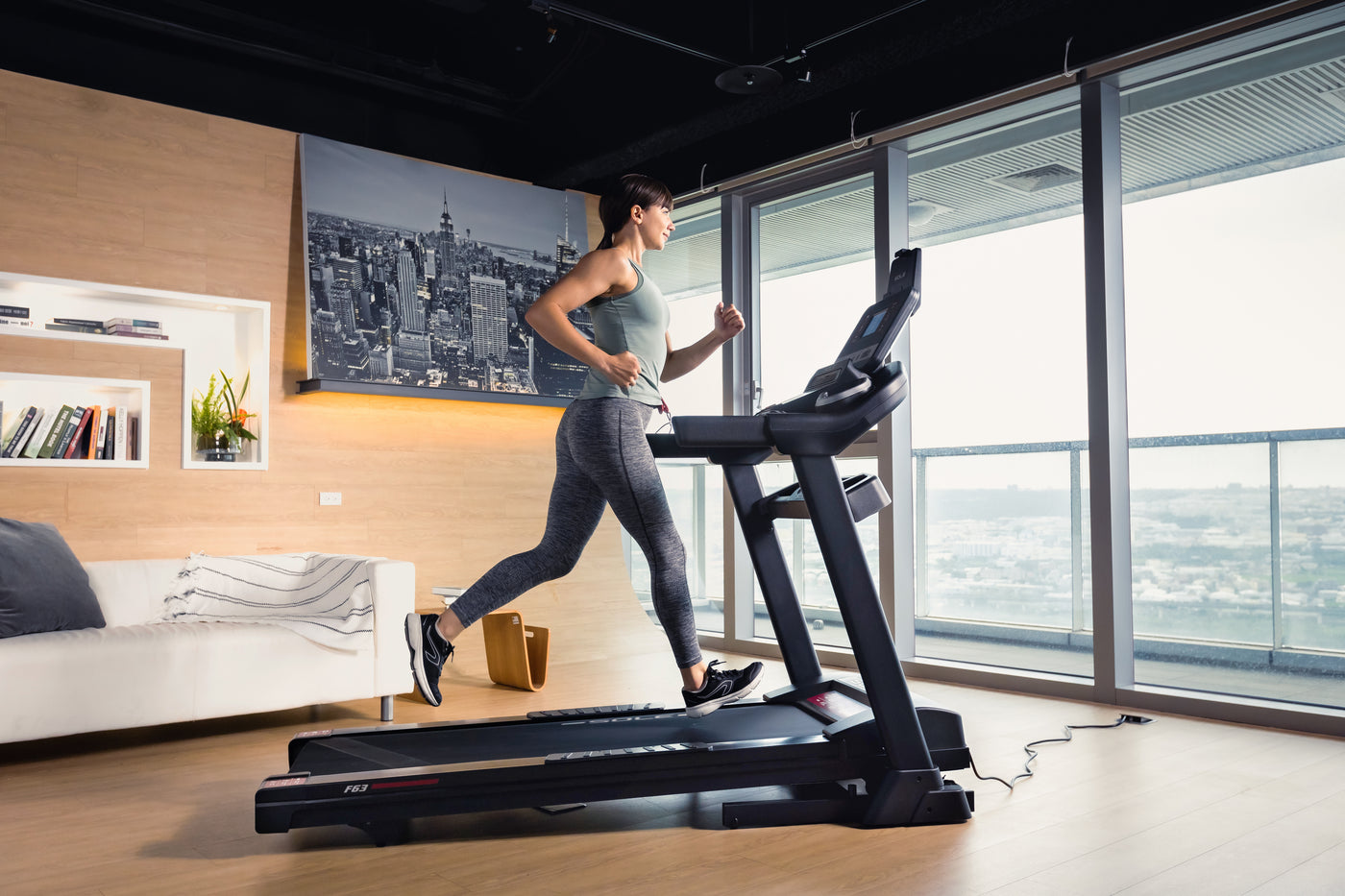 a woman running on a treadmill